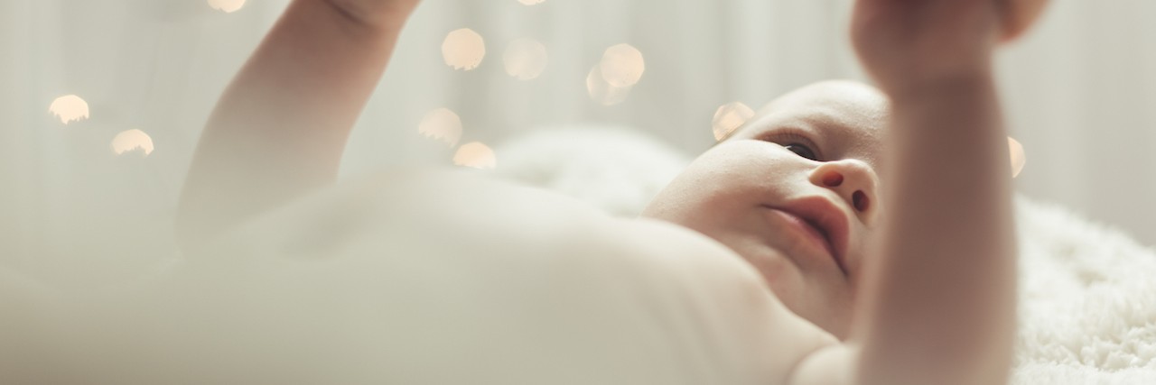 A Letter to Moms With Postpartum OCD A mother holding her baby's hands