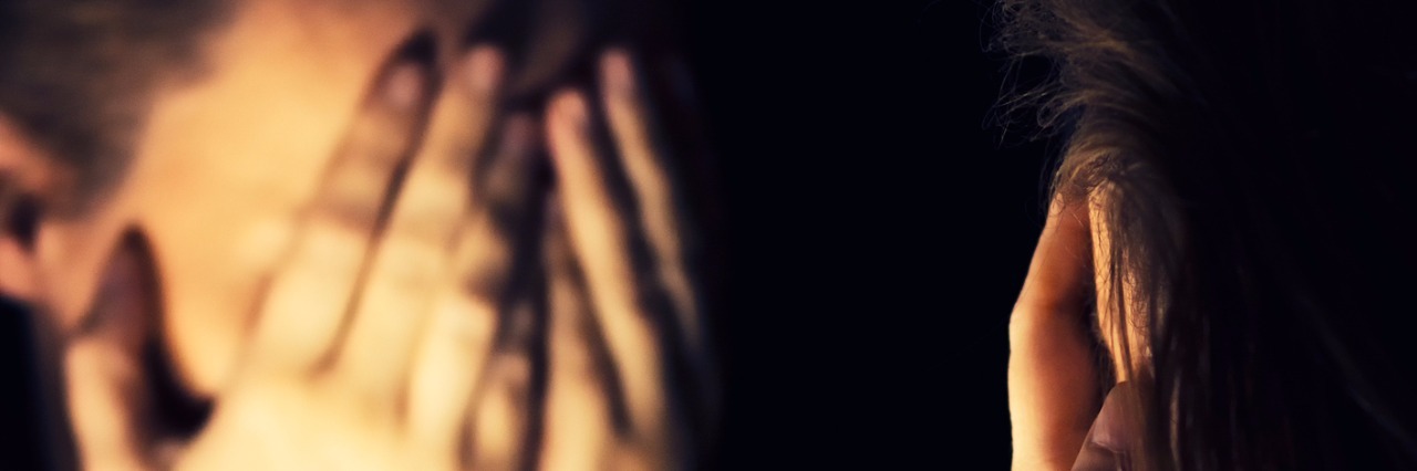 Hiding My Bipolar Disorder as I Function at Work and at Home Woman covering her face in the dark