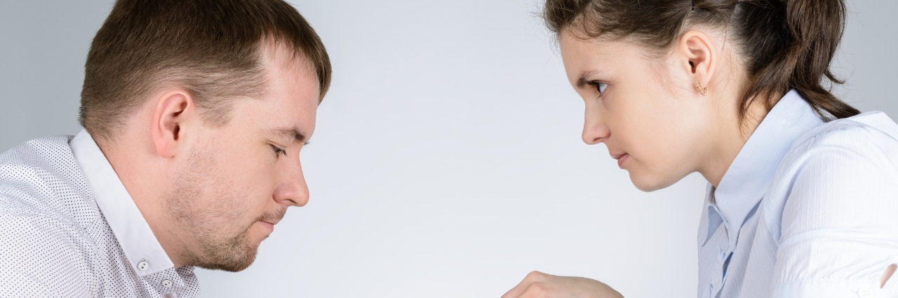 Lupus: Having a Conversation With Your Illness man and woman playing chess and staring at each other intently