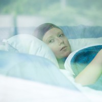 Young woman in hospital bed