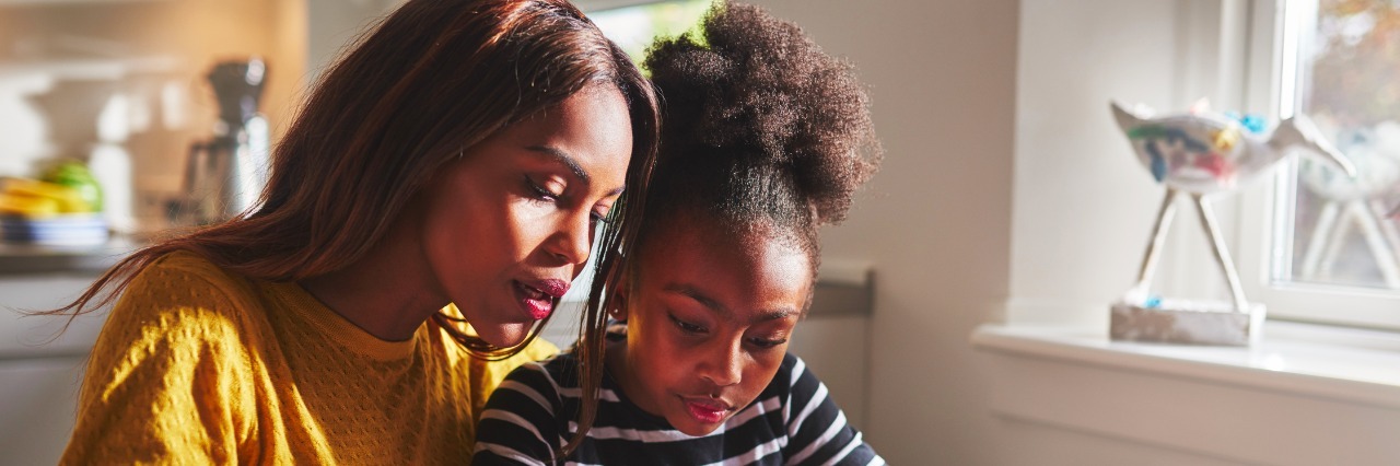 The Difference Between a Tantrum and a Meltdown little black girl learning to write the alphabet with her mother