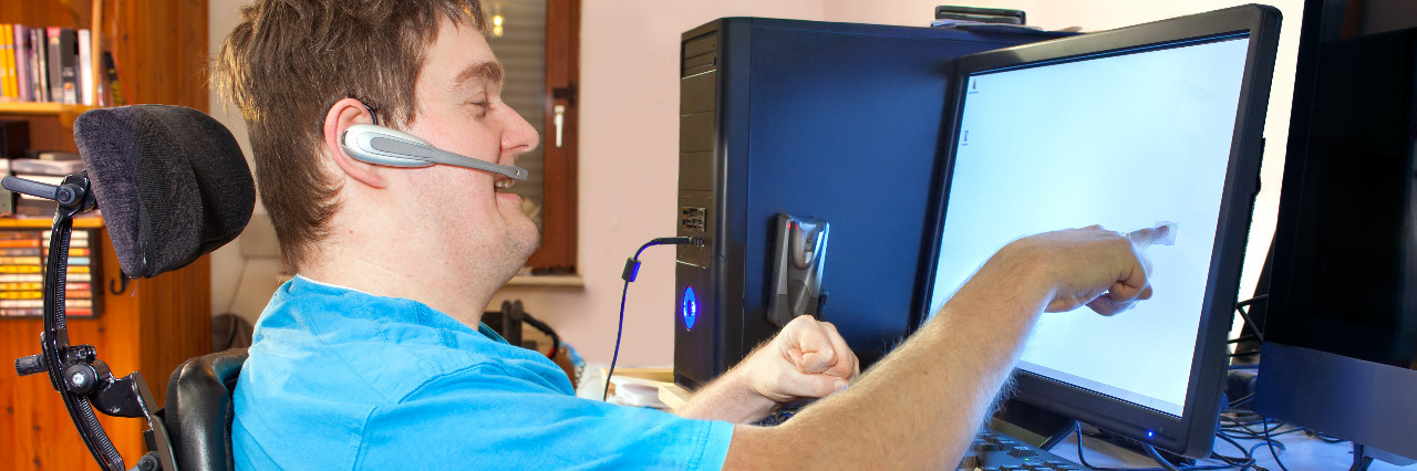 How Technology Helps People With Disabilities Man with cerebral palsy using a computer.