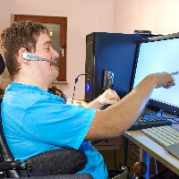 Man with cerebral palsy using a computer.