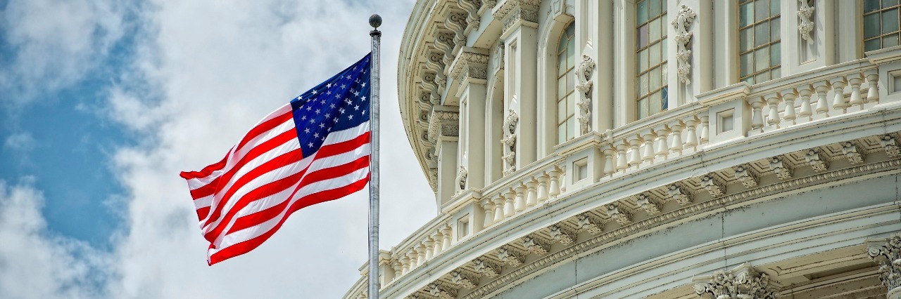 Why Health Insurance Shouldn't Be Political Washington DC Capitol dome detail with waving american flag