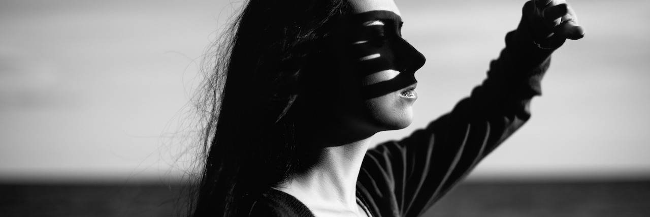 Advice to Those Who Have Friends With Borderline Personality Disorder A woman holding up her hand to stop the sun from getting in her eyes