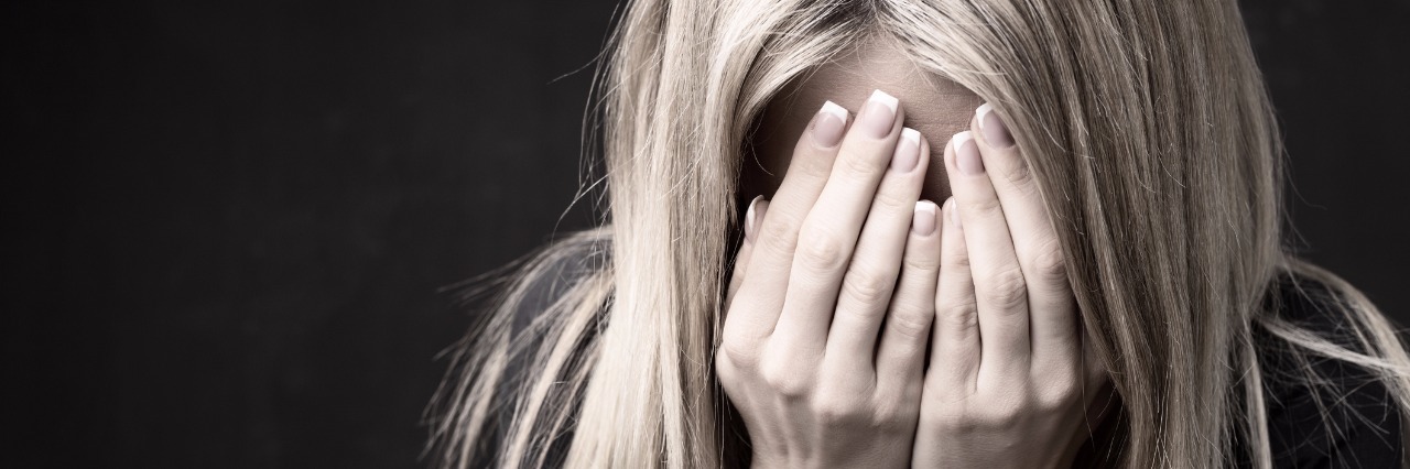 Why Not to Say It Could Be Worse About Trigeminal Neuralgia Close up of woman holding her face in her hands