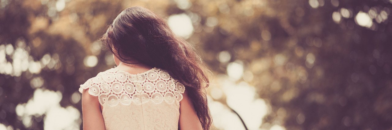 Accepting My Strengths and Challenges as an Autistic Person Woman walking in park.