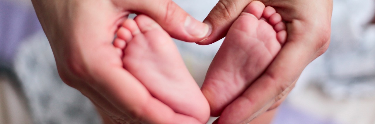 Hypoplastic Left Heart Syndrome: Keeping Hope in our Child's Fight baby feet in the mother hands forming a heart
