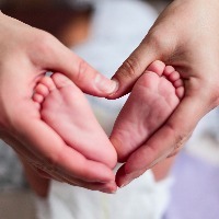 baby feet in the mother hands forming a heart