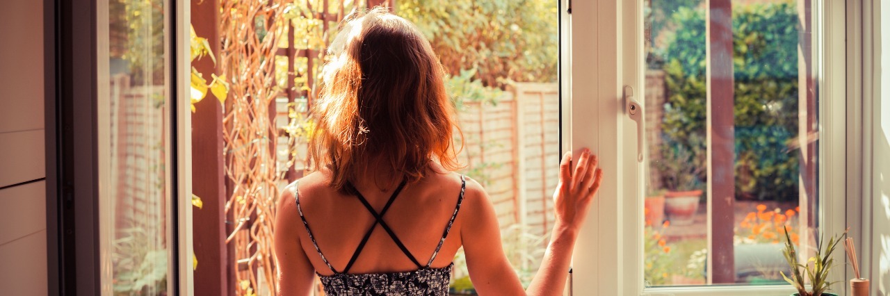 What Happens After a Borderline Personality Disorder Diagnosis woman standing in kitchen doorway at sunrise