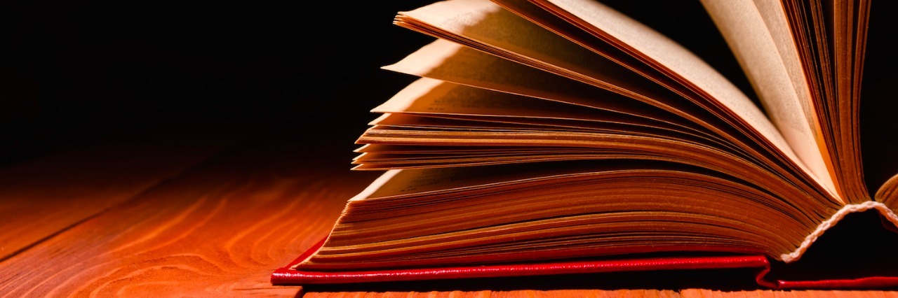 Dyslexia: How My Brain Process Information Makes Reading Not Enjoyable Book opened on wood table