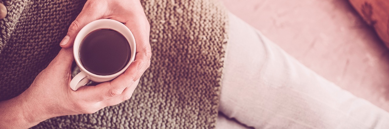 16 Things That Help My Neuropathic Pain Flare-Ups Woman on the bed with cup of coffee