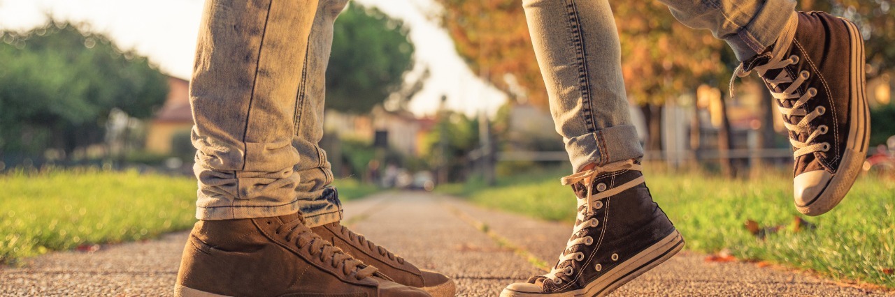 Being in a Relationship When You Have a Mental Illness couple kissing in a park. floor view