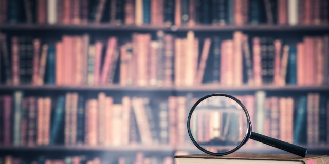 Books and magnifying glass