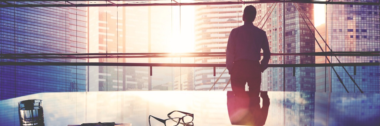 How Redefining 'Success' Helped Me Through Depression business man looking through a window