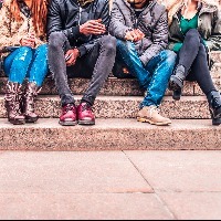 Group of people sitting on a staircase outdoors