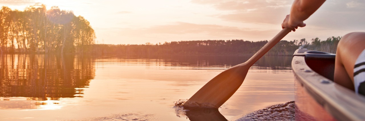 What I Learned at Young Adult Cancer Camp Woman canoeing at sunset on Jackfish Lake, Manitoba.