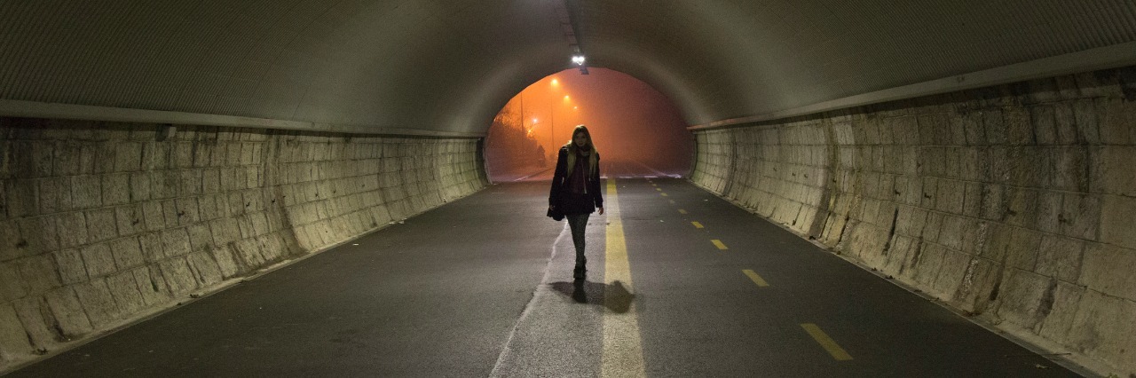 Loss: How the Death of a Loved One Changes You young lady walks alone trough a tunnel in the night
