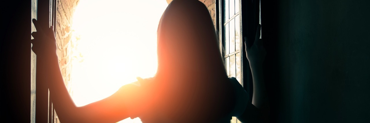 woman opens windows and enjoys the landscape