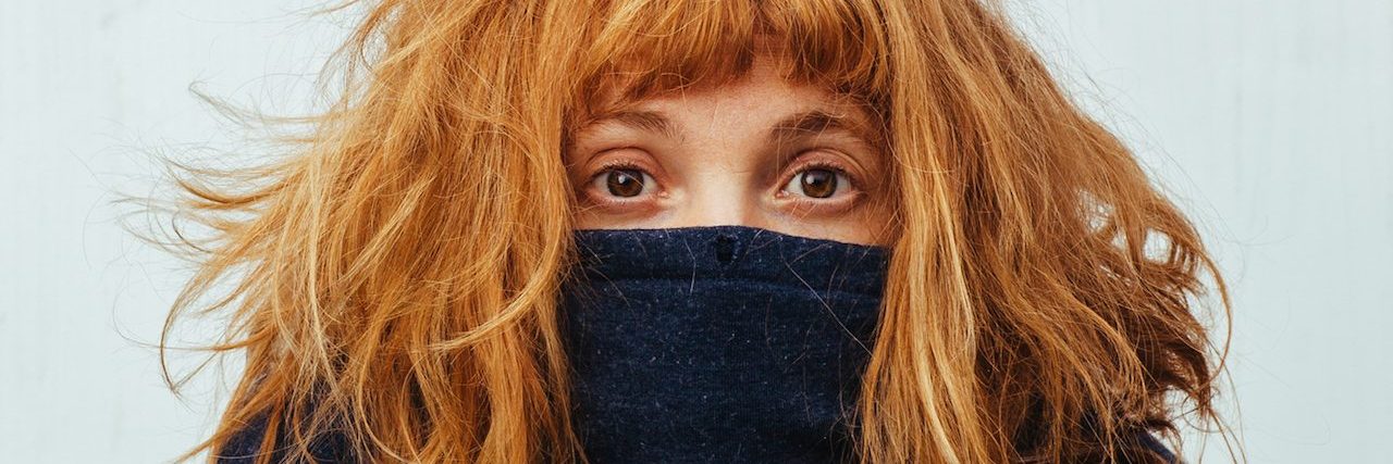 What People Don't Realize You're Doing Because of Your Social Anxiety Shy woman hides in her sweater.