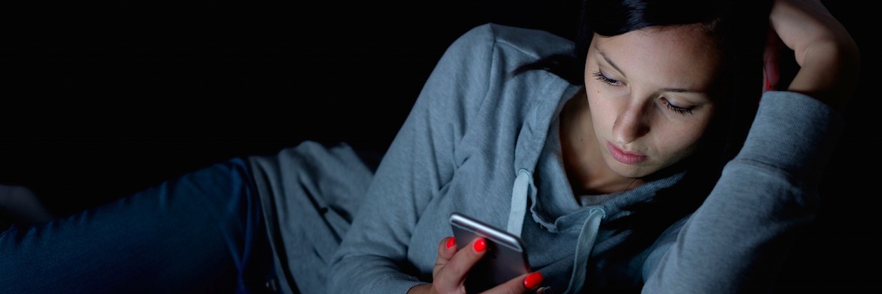 5 Things You Should Know When I'm Depressed and Text You at Night Portrait of young woman looking at the mobile phone screen at night