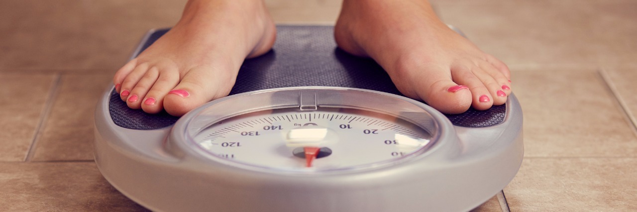 Chronic Lung Disease: Weight Loss Does Not Equal Happiness woman's feet standing on a scale in the bathroom