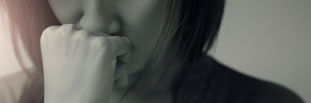 5 Stigmas About Borderline Personality Disorder sad woman pressing her fist to her mouth