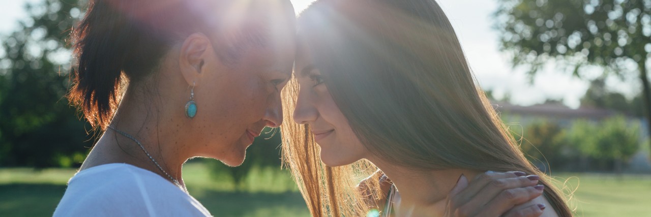Learning How to Help My Teenager With Mental Health Issues Daughter with mother hugging at sunset