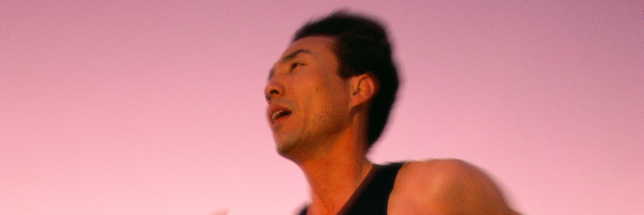 Mid adult man jogging on the beach