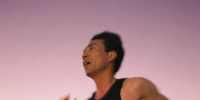 Why I'm Training for a Half-Ironman -- Without a Stomach Mid adult man jogging on the beach