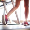 Legs of sportswoman during training on treadmill