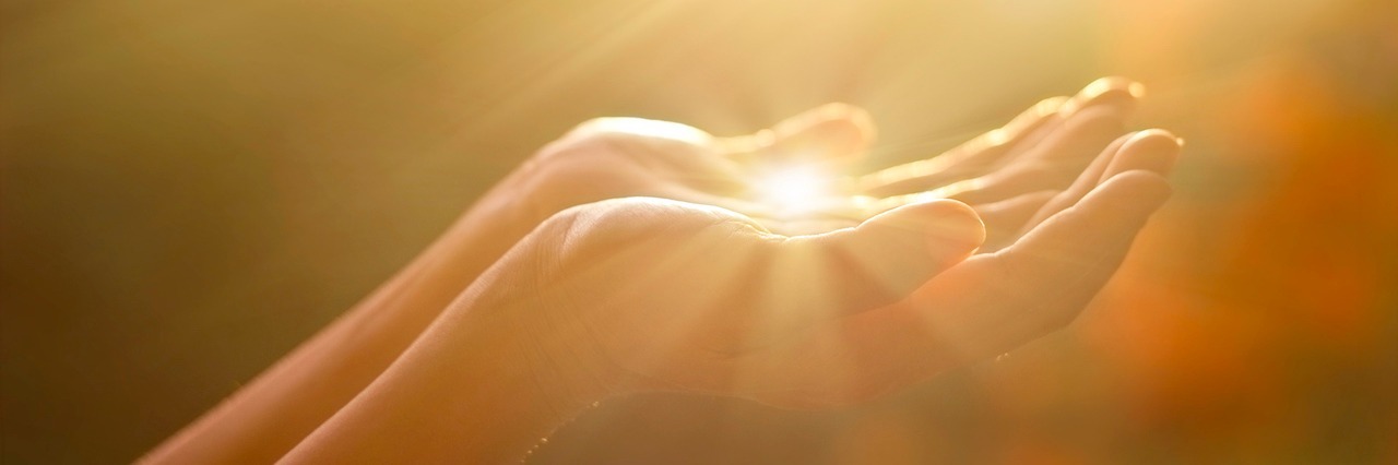 Choosing Gratitude in Recovery From an Eating Disorder woman holding her hand in sunlight