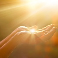 woman holding her hand in sunlight