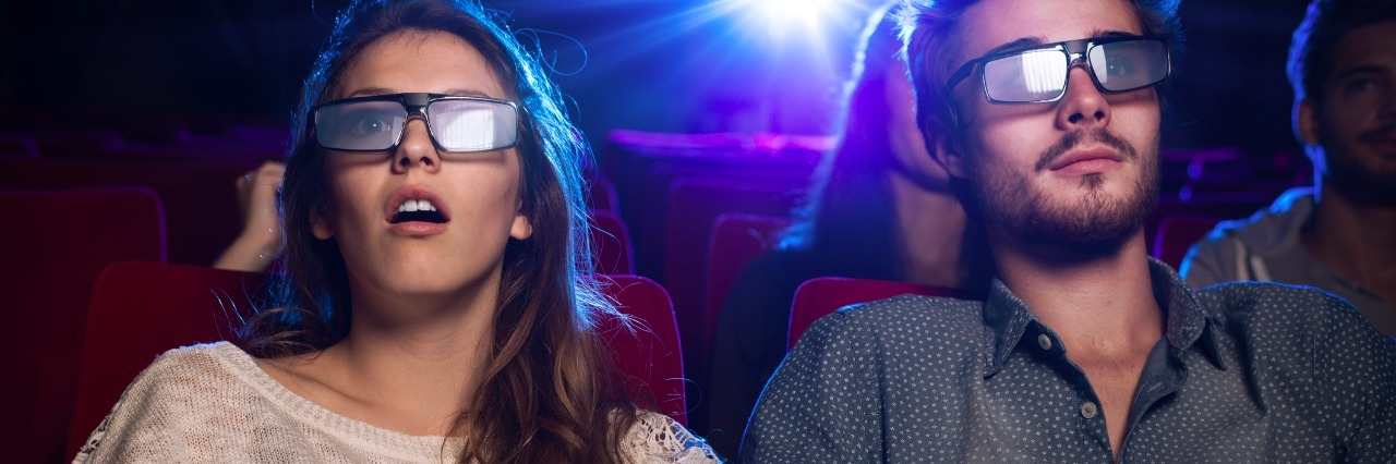 Couple watching a movie wearing 3-D glasses