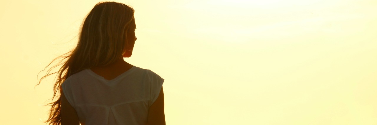 Thyroid Cancer and Responding to 'At Least You Didn't Lose Your Hair' Rear view of young woman at sunset