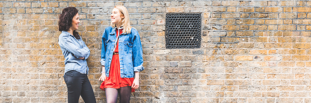 Lessons From My Best Friend Who Has Borderline Personality Disorder two girls standing against a wall outside