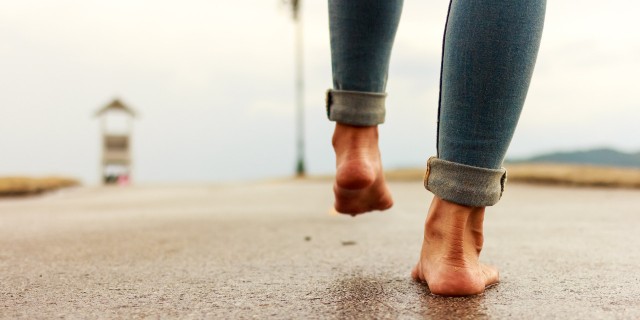 How I'm Getting My Legs Back After a Rare Dystonia Diagnosis Woman walking barefoot down a path.