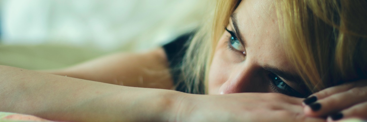 What Mornings With Anxiety Are Like sad woman laying down in a bed