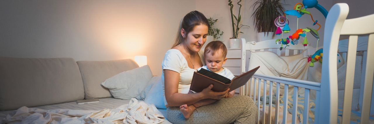 How Reading Books to My Son Helped Me With Postpartum Depression Mother holding baby boy on knees and reading book