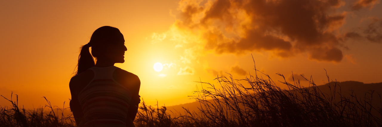 Woman watching beautiful sunset.