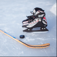 Hockey stick and puck on the ice rink.