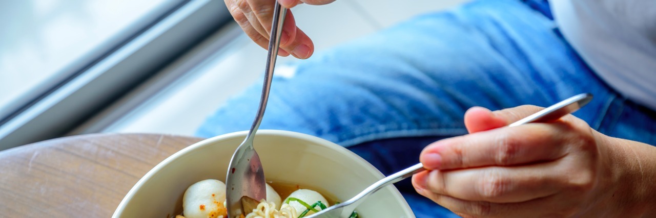 Celiac Disease: To the Girl Who Said 'You Don't Deserve Good Food' Top view of woman eating bowl of food