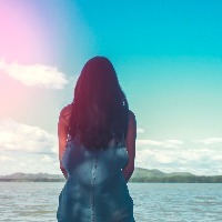 woman sit alone at the edge of the bridge