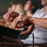 People eating popcorn in movie theater