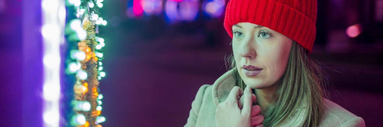 Letter About Touching Strangers, From a Rape Survivor With PTSD Lonely Christmas woman on the winter street at night.