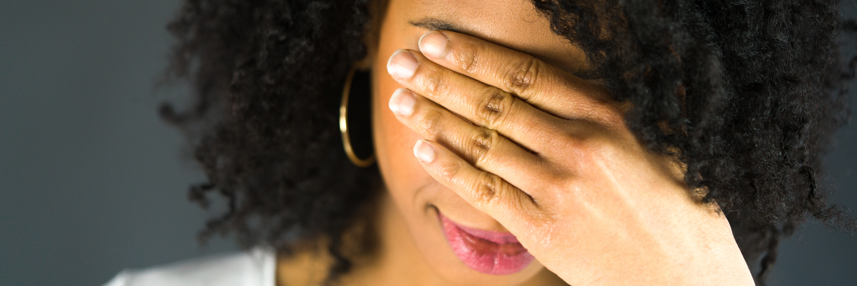 a woman covering her head with her hands