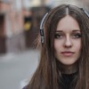 Girl hipster in headphones looking at camera