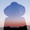 double exposure of a woman wearing a large hat and a sunset behind a mountain with birds flying in the air