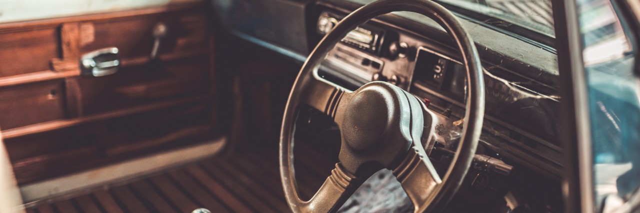 Old rusty steering wheel vehicle car in a vintage style.