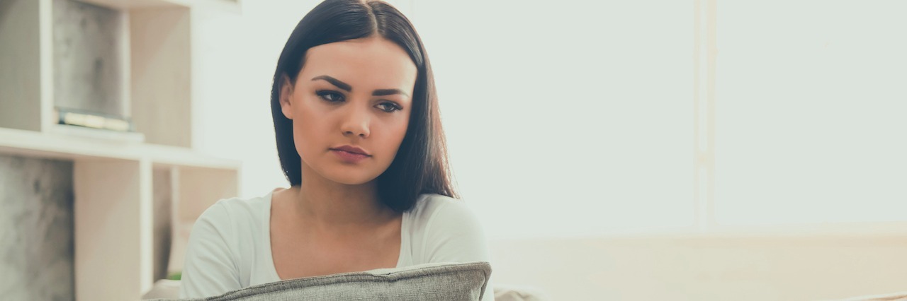 Letter to the Psychiatrist Who Told Me I Should 'Find God' Girl at the psychologist hugging a pillow and sitting on a couch